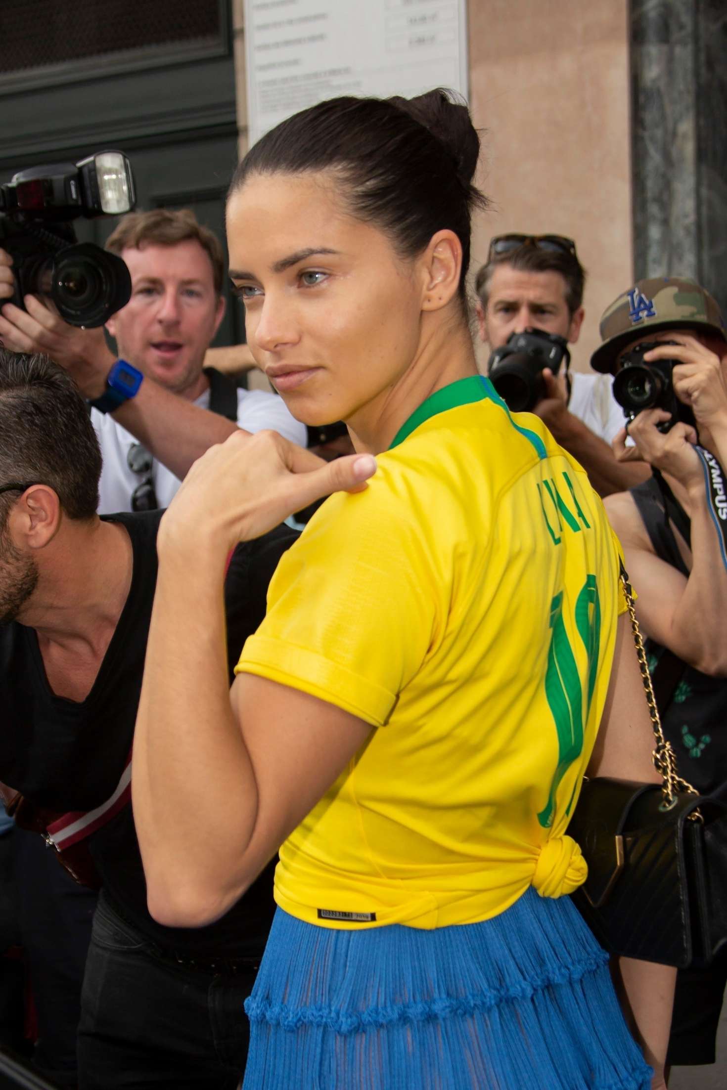 Adriana Lima in a patriotic Brazil football shirt out in Paris