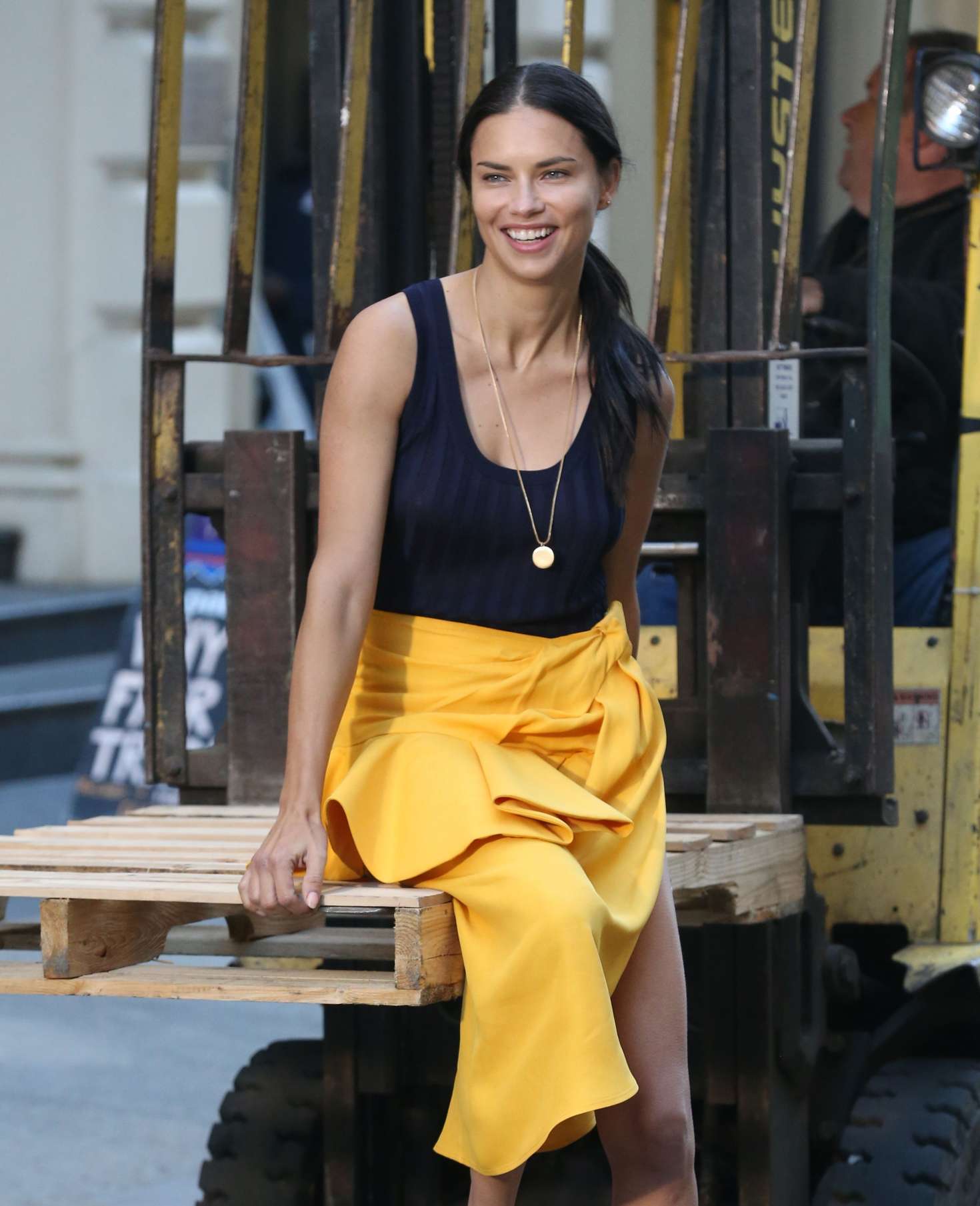 Adriana Lima in Bright Yellow Frilly Skirt on a photoshoot in NYC