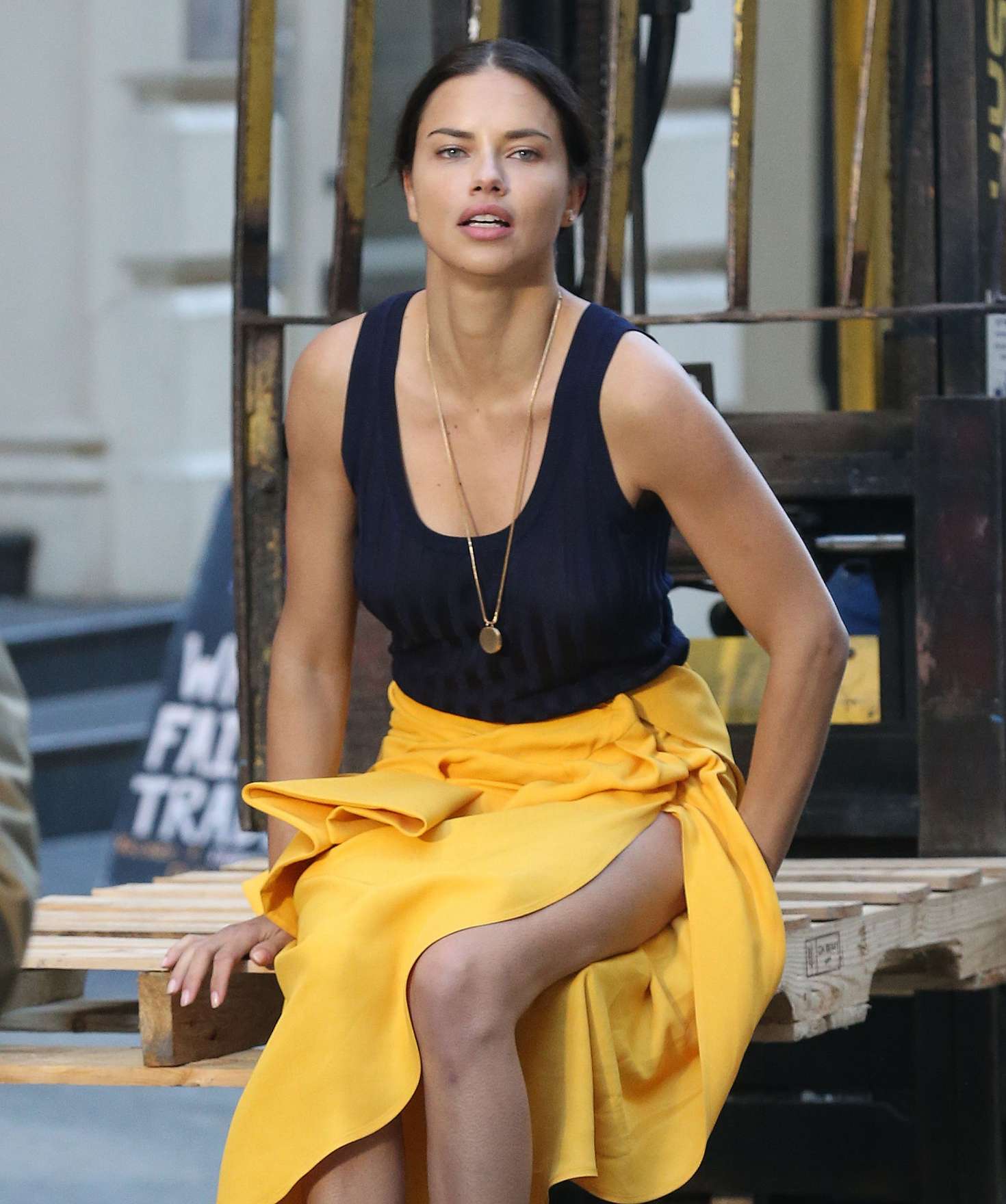 Adriana Lima in Bright Yellow Frilly Skirt on a photoshoot in NYC