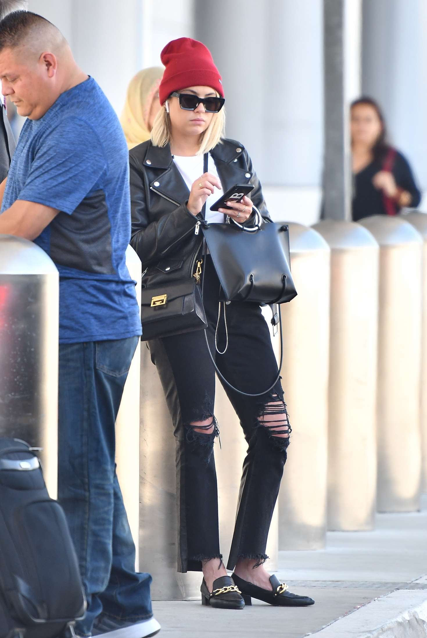 Ashley Benson â€“ Waiting for her car at the LAX airport in Los Angeles