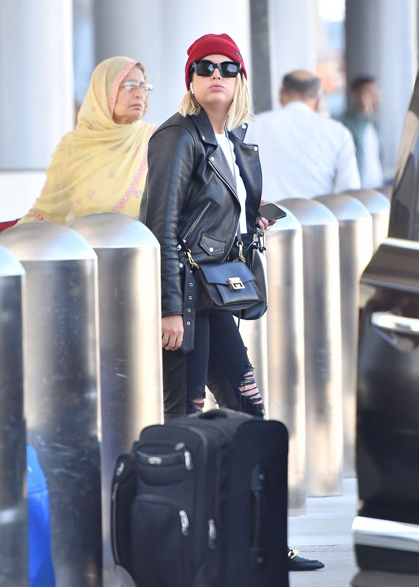 Ashley Benson â€“ Waiting for her car at the LAX airport in Los Angeles