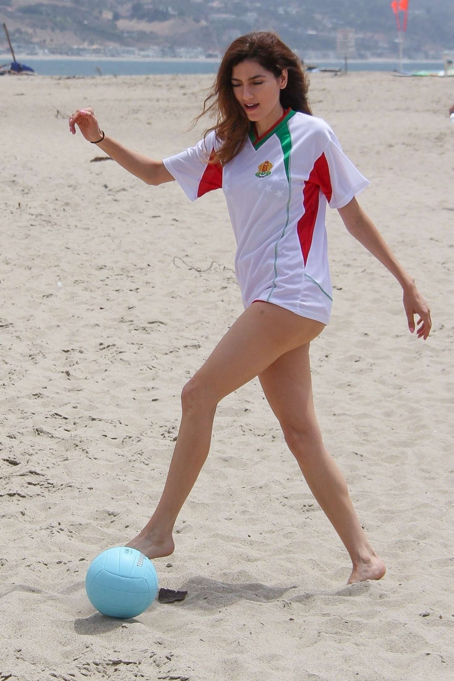 Blanca Blanco in Red Shorts on the beach in Malibu