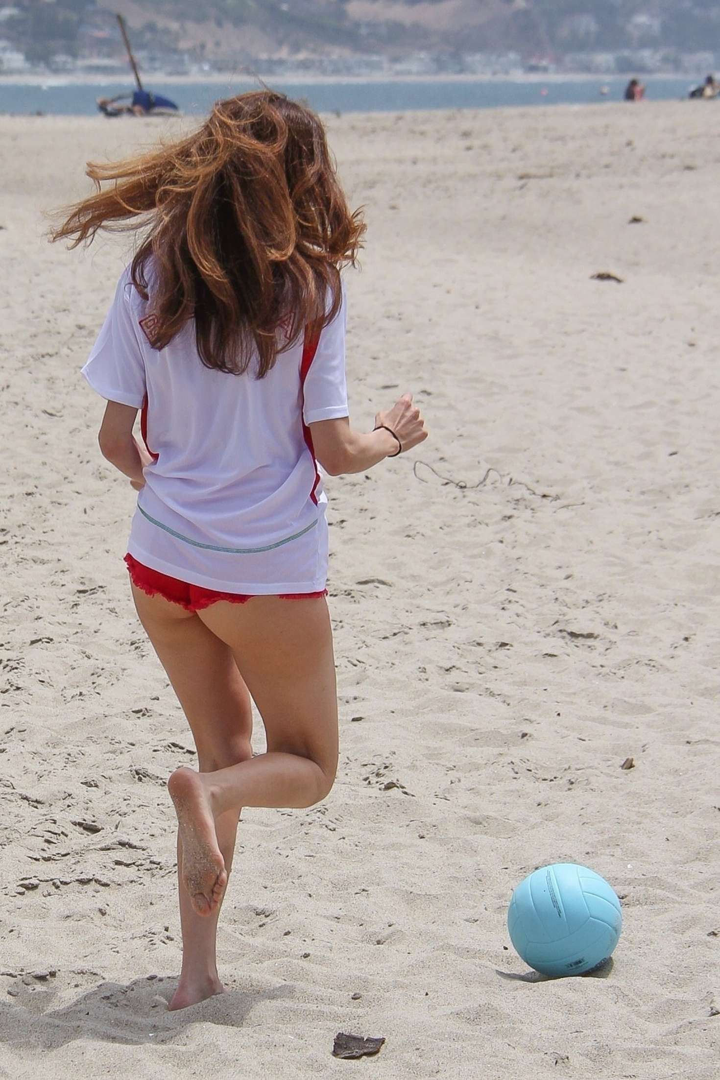 Blanca Blanco in Red Shorts on the beach in Malibu