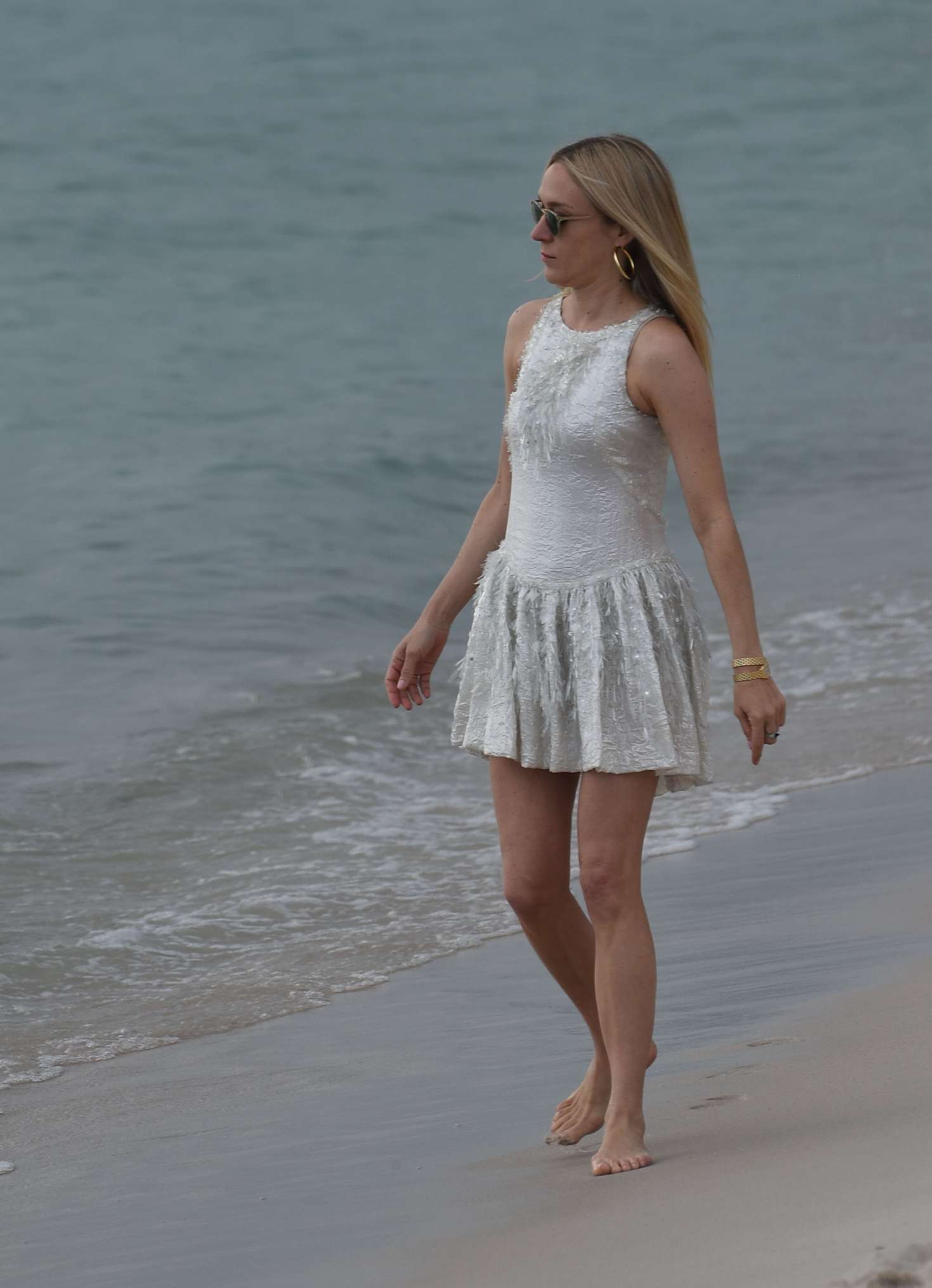 Chloe Sevigny in White Mini Dress on the beach in Cannes