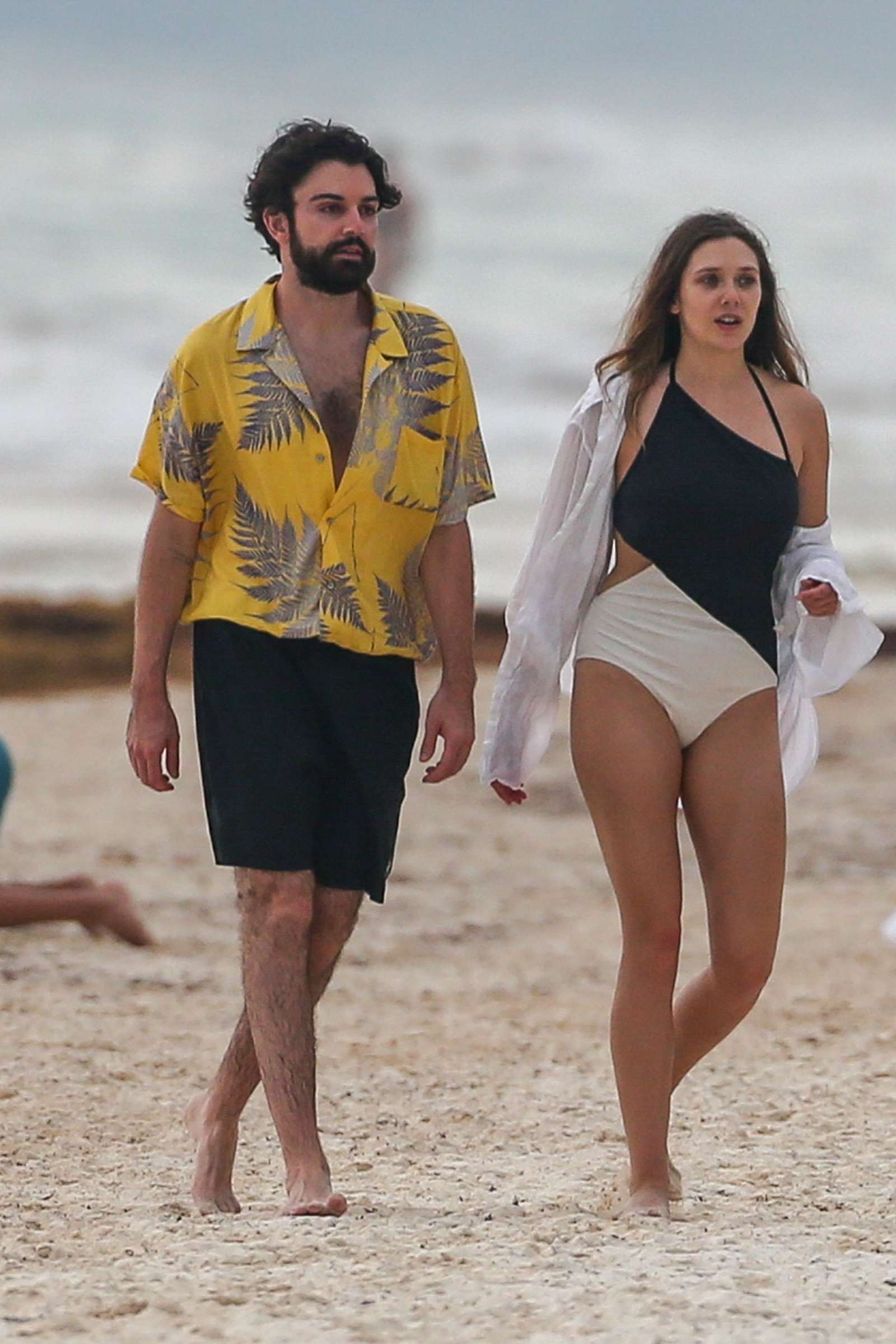 Elizabeth Olsen in Black and White Swimsuit at a beach in Mexico
