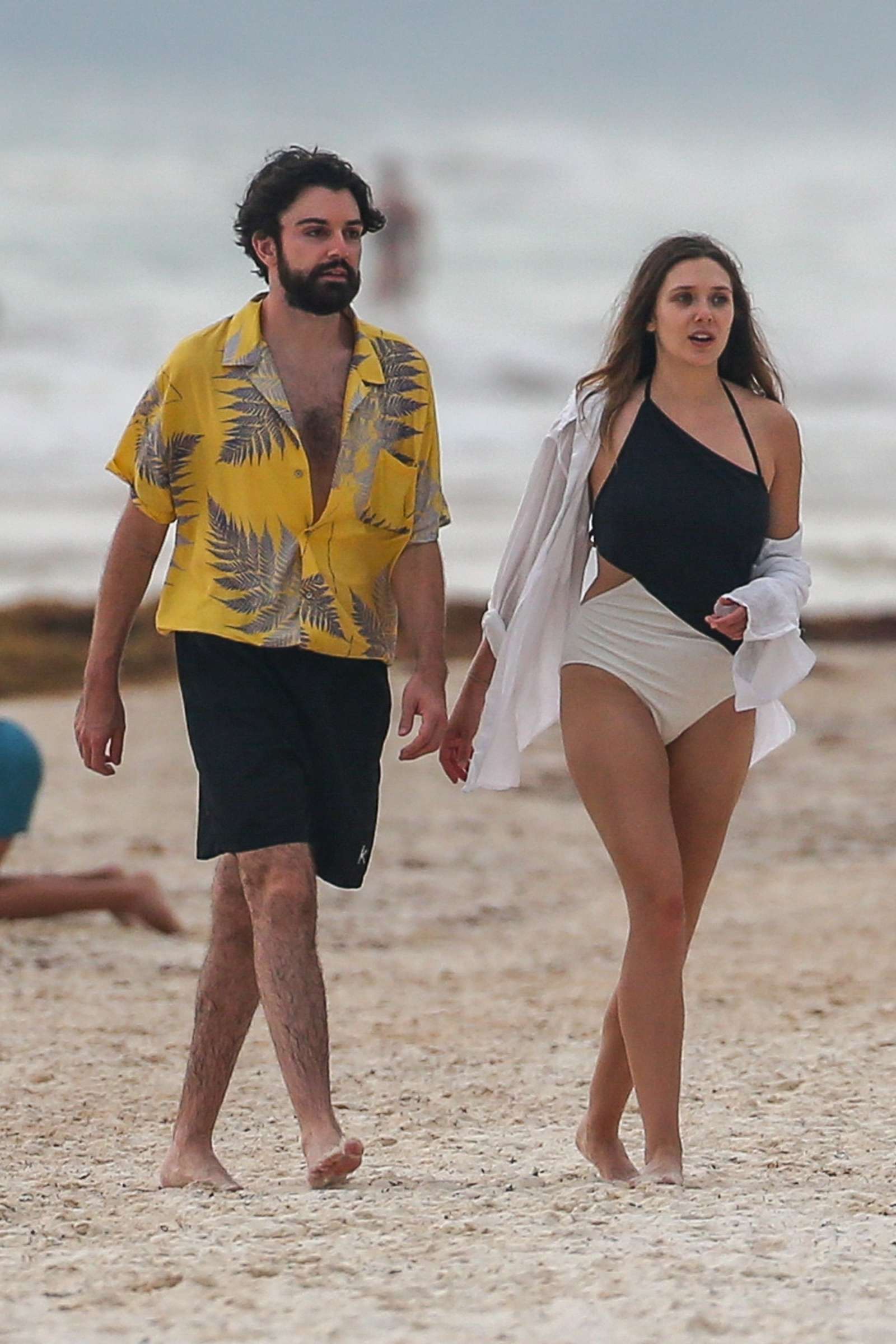 Elizabeth Olsen in Black and White Swimsuit at a beach in Mexico