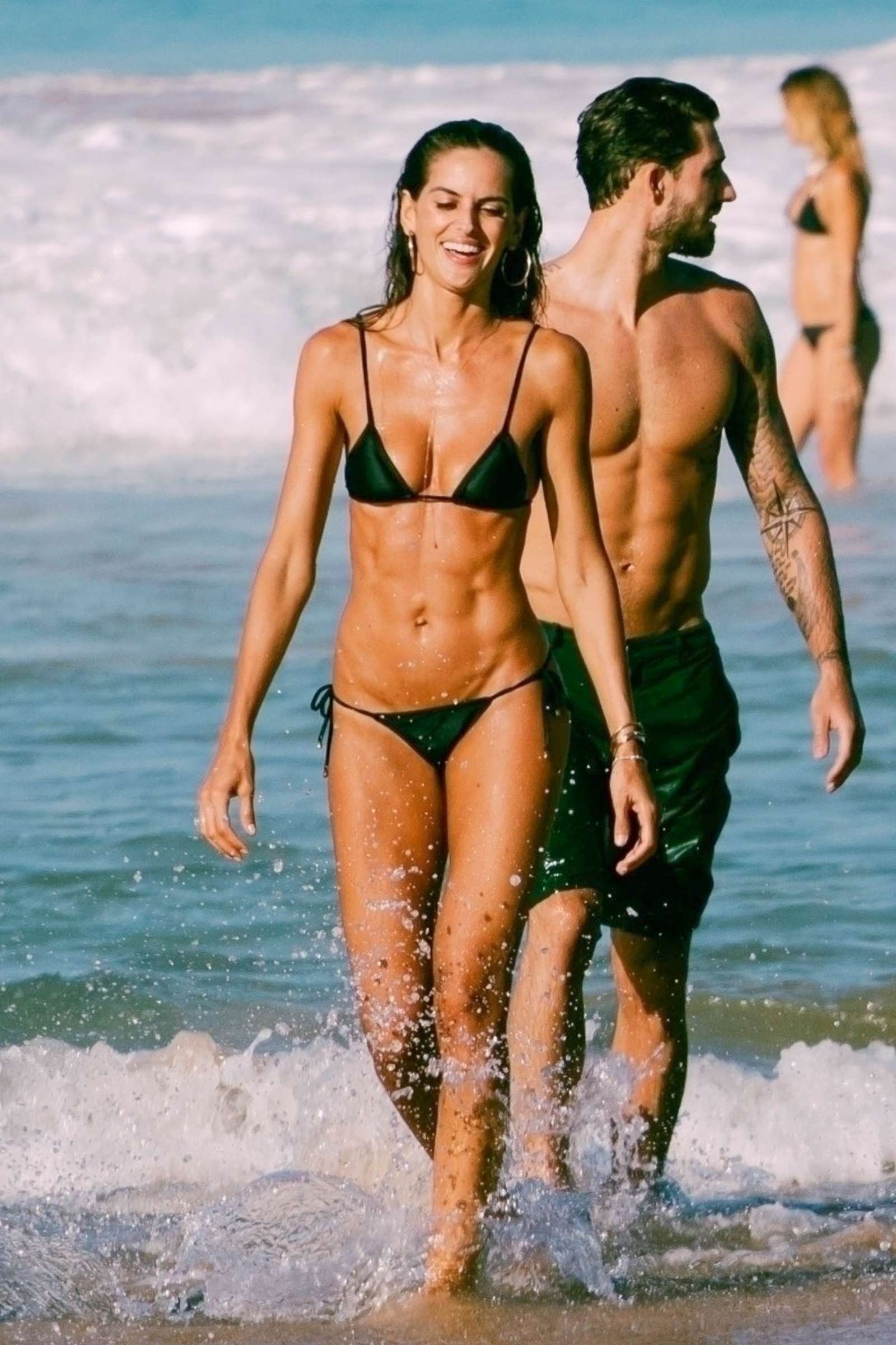 Izabel Goulart in Black Bikini at the beach in Brazil