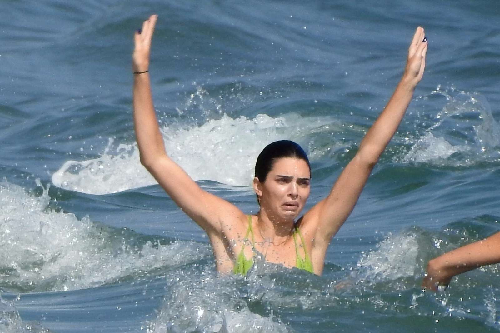 Kendall Jenner in a skimpy neon green bikini on the beach in Malibu