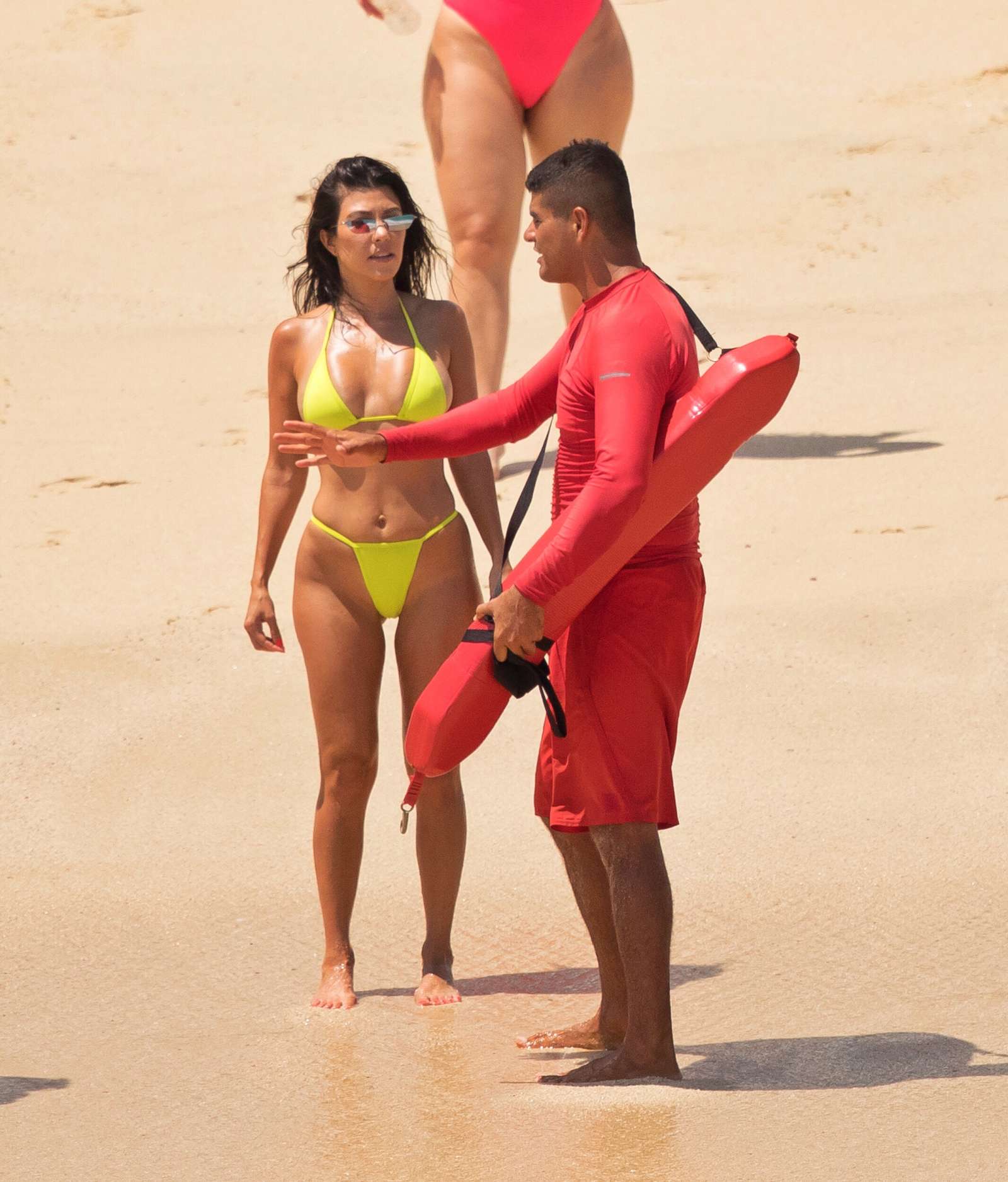 Kourtney Kardashian in Yellow Bikini on the beach in Cabo