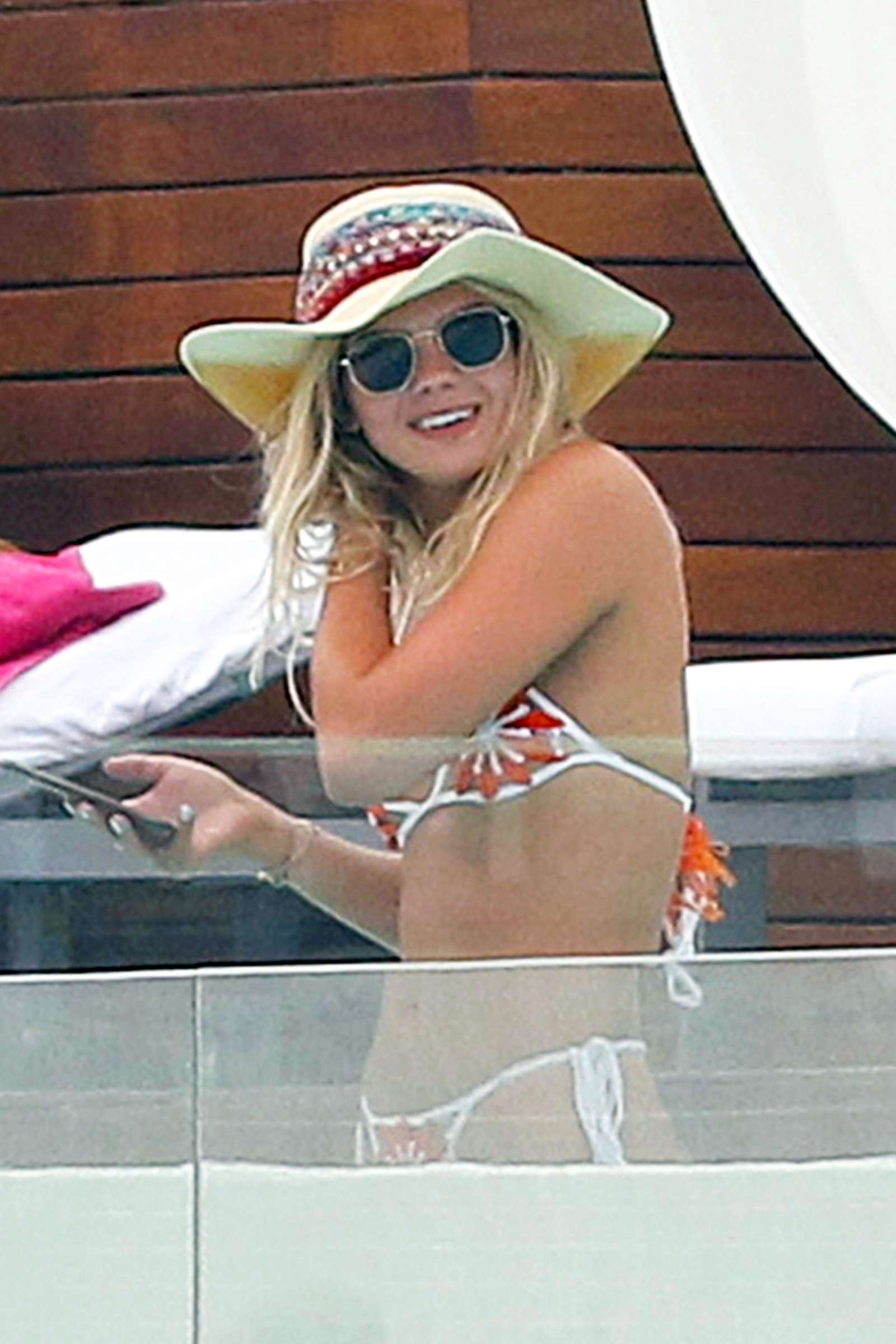 Louisa Johnson â€“ Bikini by the pool with a friend in Ibiza