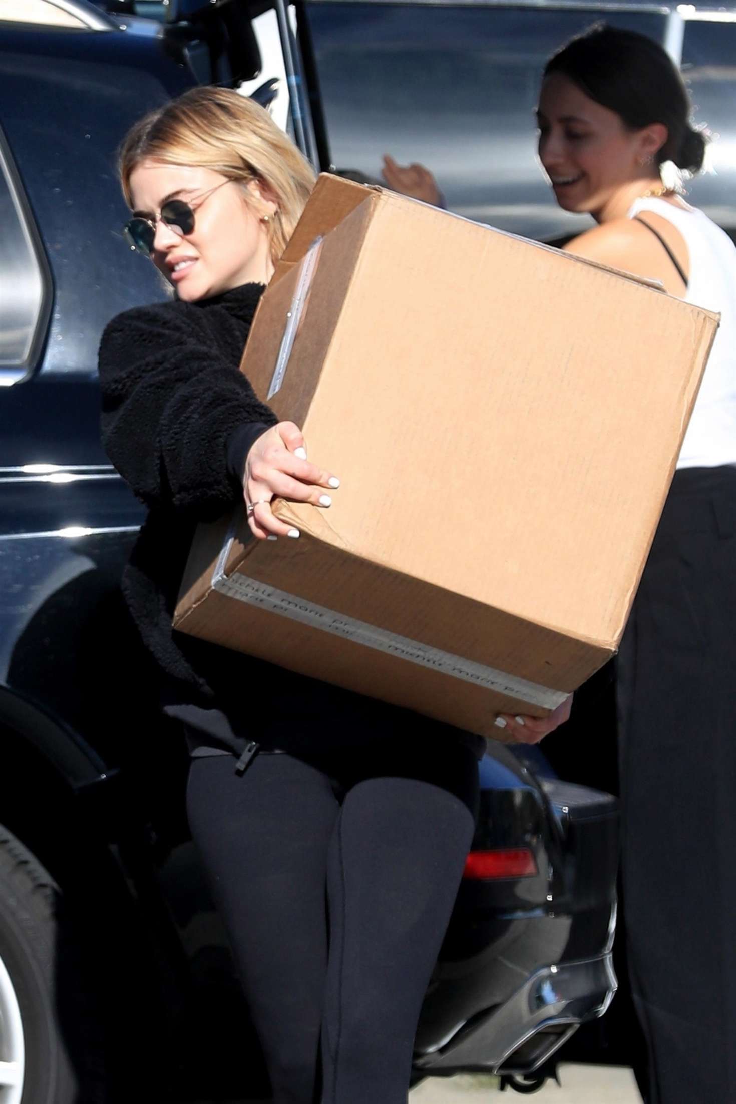 Lucy Hale â€“ Handling a large package in Beverly Hills