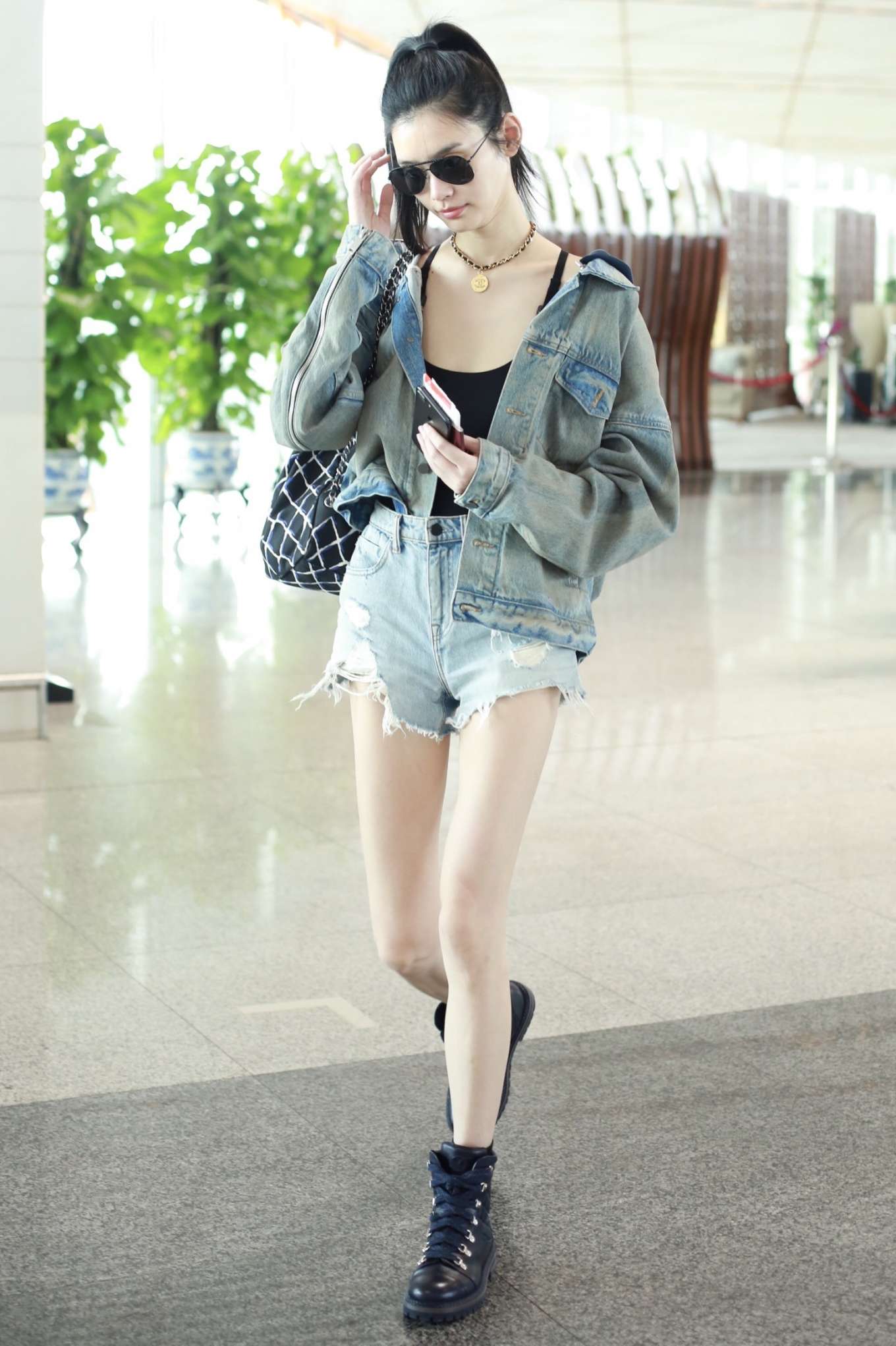 Ming Xi in Jeans at Beijing International Airport