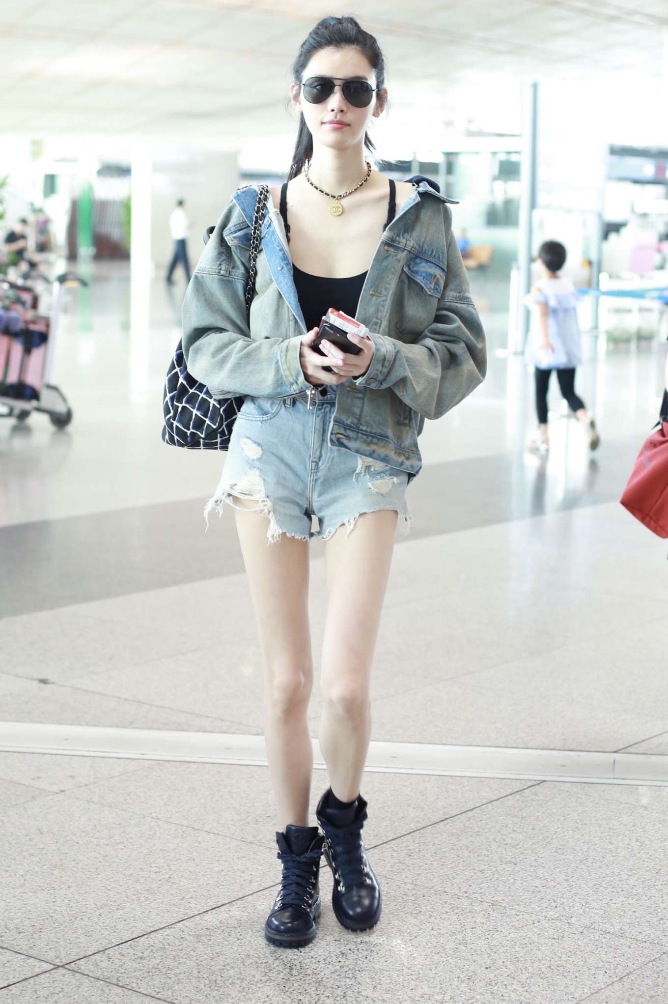 Ming Xi in Jeans at Beijing International Airport