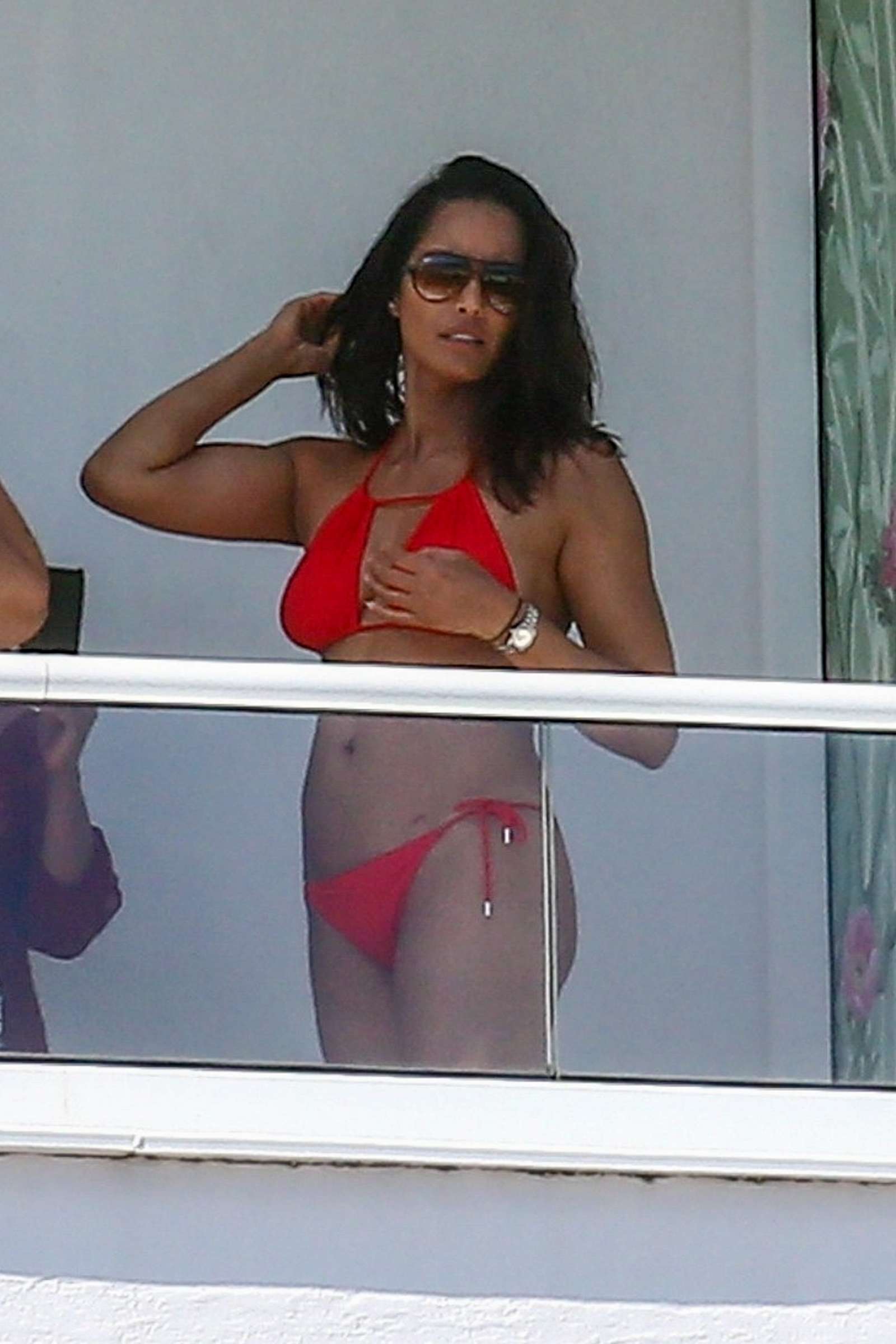 Padma Lakshmi in Red Bikini on her hotel balcony in Miami