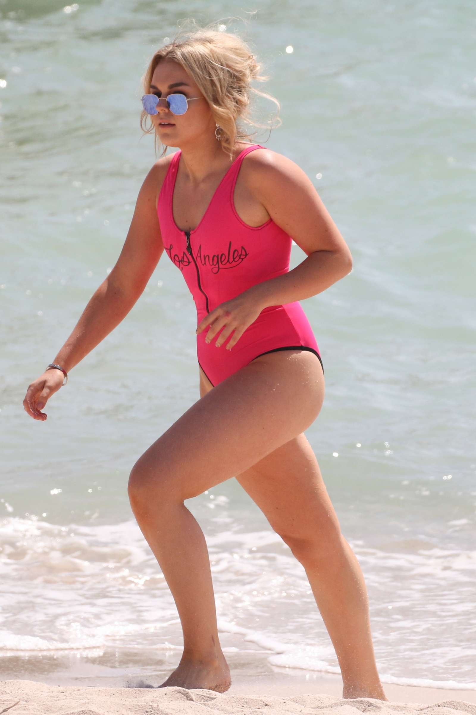 Tallia Storm in Neon Pink Swimsuit on the beach at Cannes