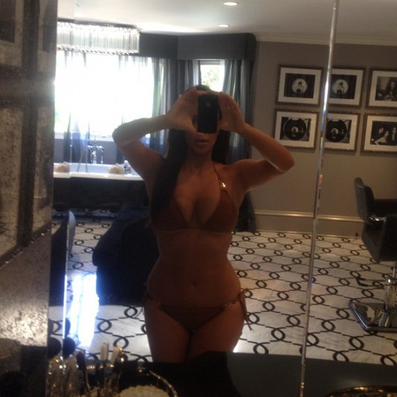 Kim Kardashian taking pics of herself in a bikini