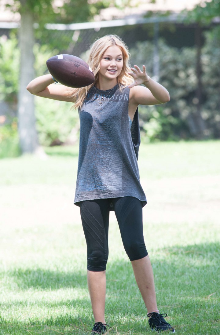 Olivia Holt - Playing Football at a park in Sherman Oaks