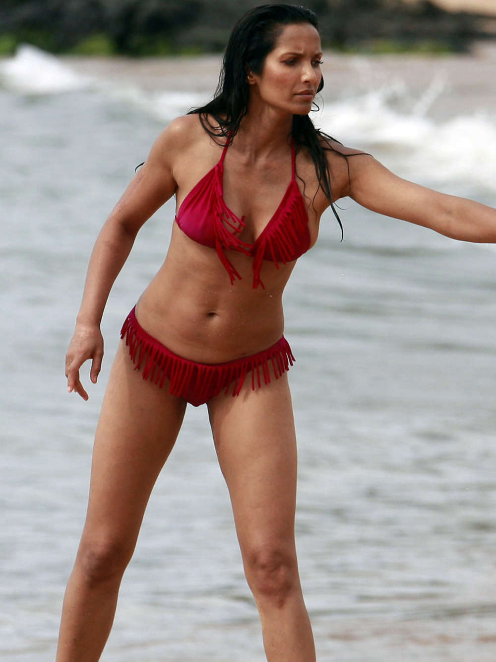 Padma Lakshmi in a bikini at a beach in Hawaii. 