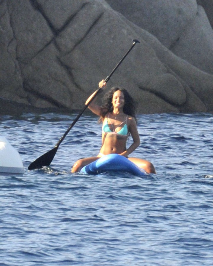 Rihanna paddleboarding in a bikini on vacation in Italy