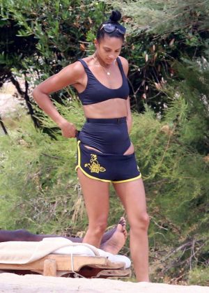Alesha Dixon in Shorts and Bikini Top on the beach in Sardinia