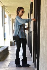 Alessandra Ambrosio - checks her phone on her way in and out of a day spa in LA