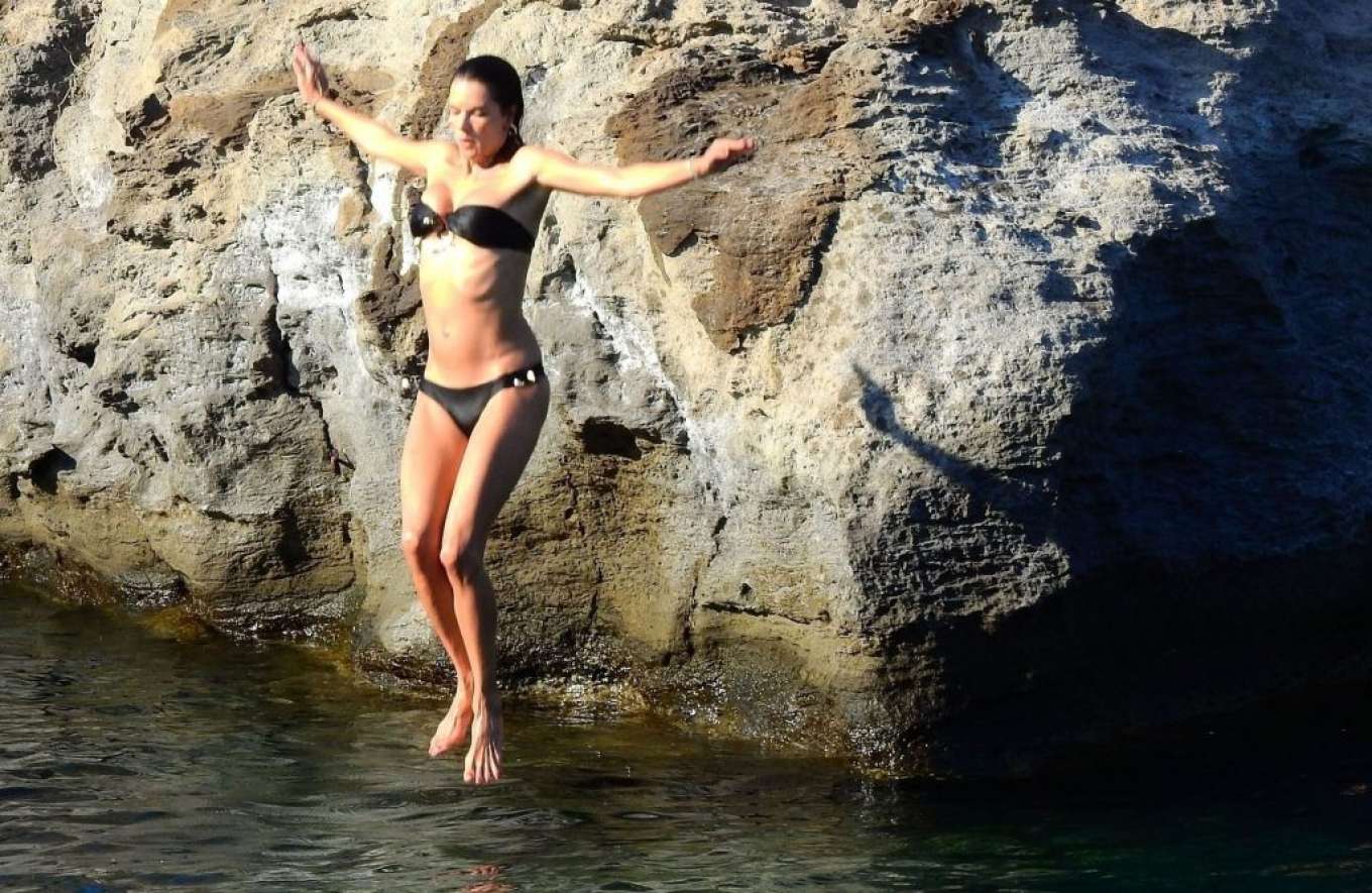 Alessandra Ambrosio in Black Bikini on the beach in Eden Garden