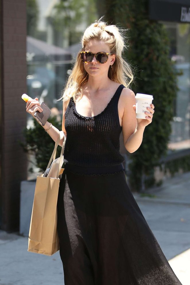 Alice Eve in black dress shopping on Melrose Place in West Hollywood