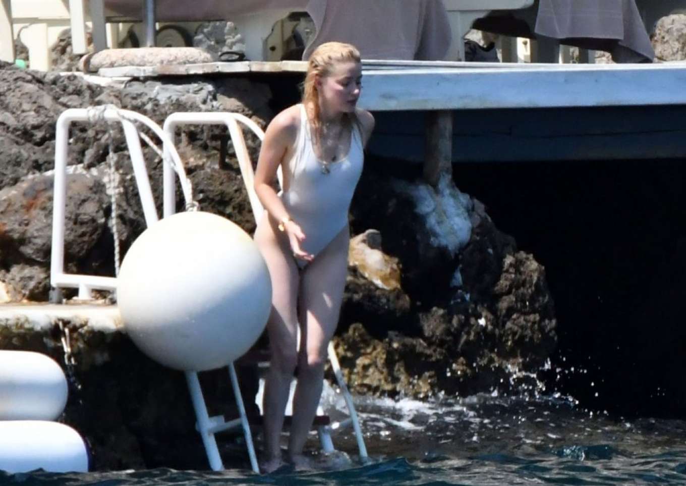 Amber Heard in White Swimsuit on holiday in Amalfi Coast. 