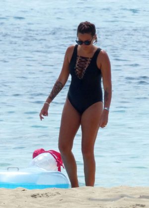 Angel Flukes in Black Swimsuit on a beach in Palma