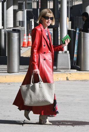 Anna Wintour - In red leather coat and snakeskin boots seen at JFK Airport
