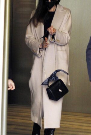 Anne Hathaway - Wearing a protective face mask while leaving a hotel in Milan