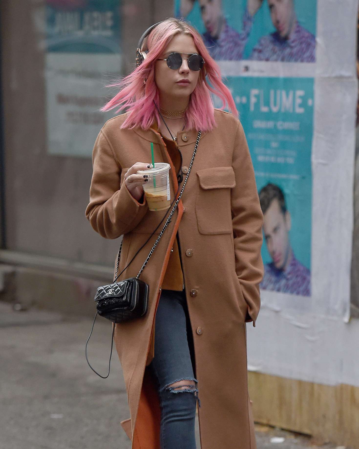 Ashley Benson 2016 : Ashley Benson in a beige coat while listening to music -09