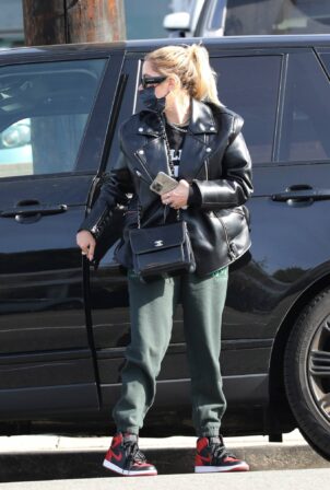 Ashley Benson - In green sweatpants and a black leather jacket shopping in West Hollywood
