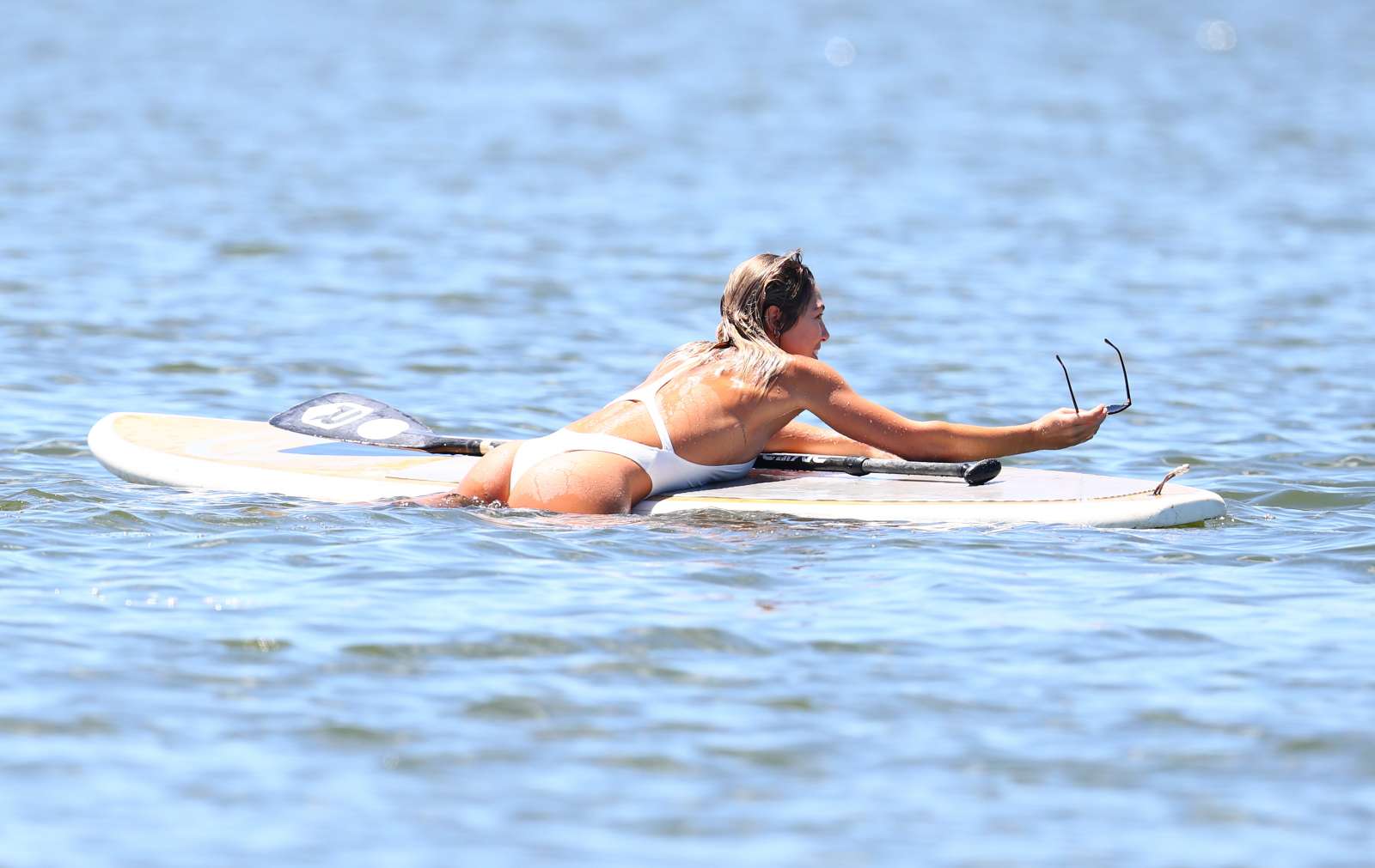 Ashley Hart in White Swimsuit Paddleboarding in New York. 