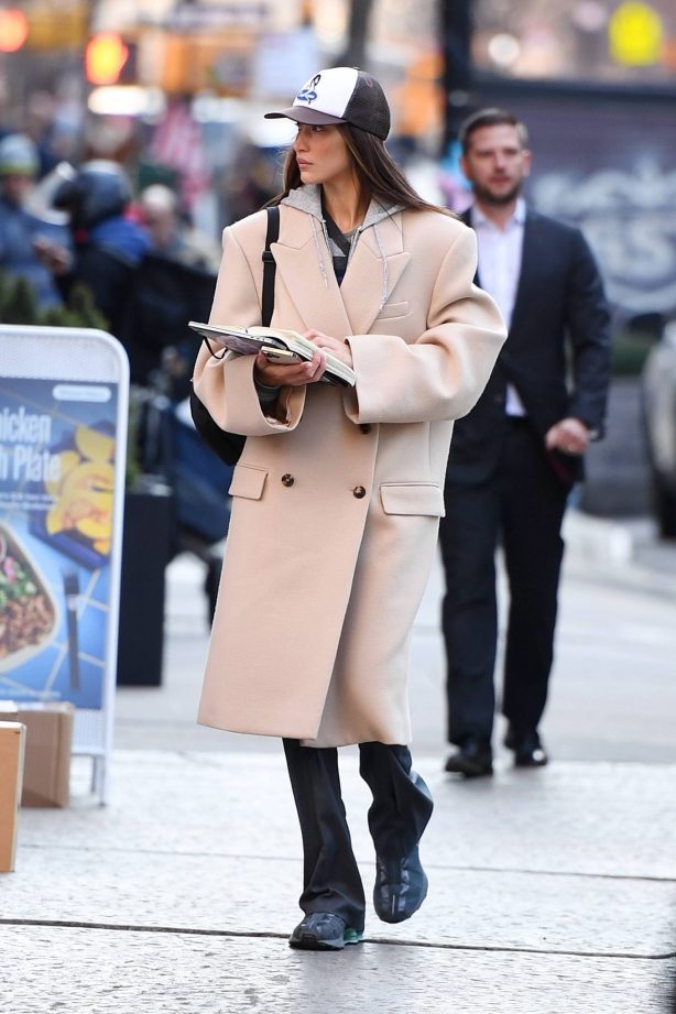 Bella Hadid - Spotted on Manhattan with a trench coat and Salomon sneakers