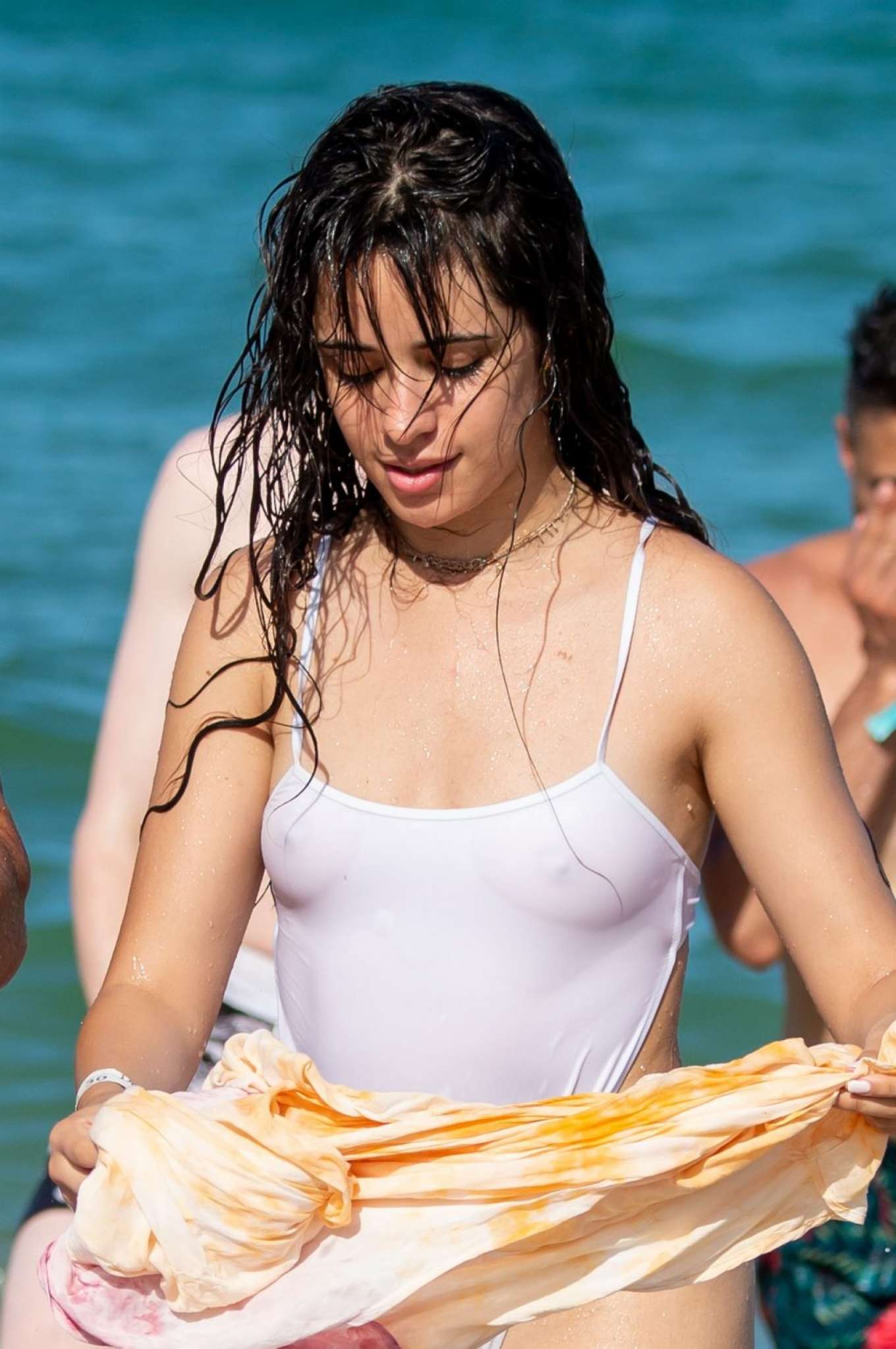 Camila Cabello in White Swimsuit on the beach in Miami Beach. 