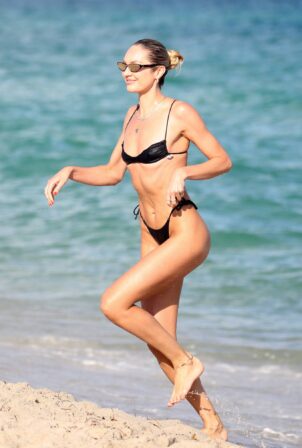 Candice Swanepoel - In a black bikini at the beach in Miami