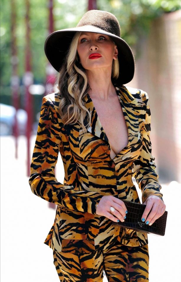 Caprice Bourret in a Plunging Tiger Print Power Suit in London