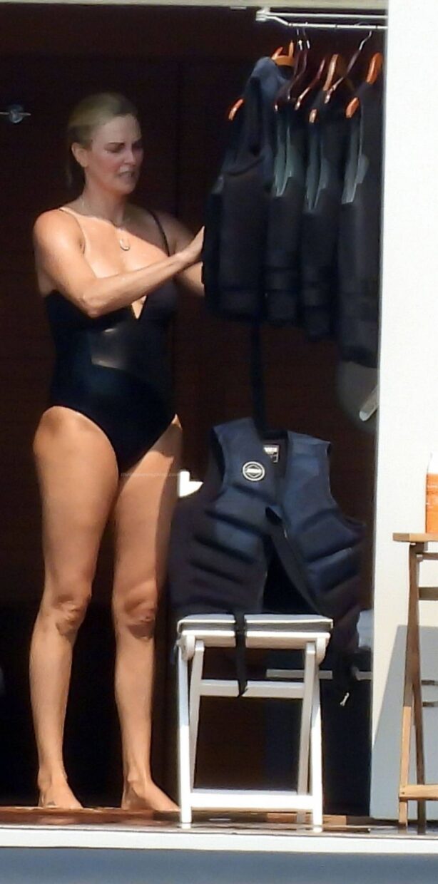 Charlize Theron - In a black swimsuit in Greece
