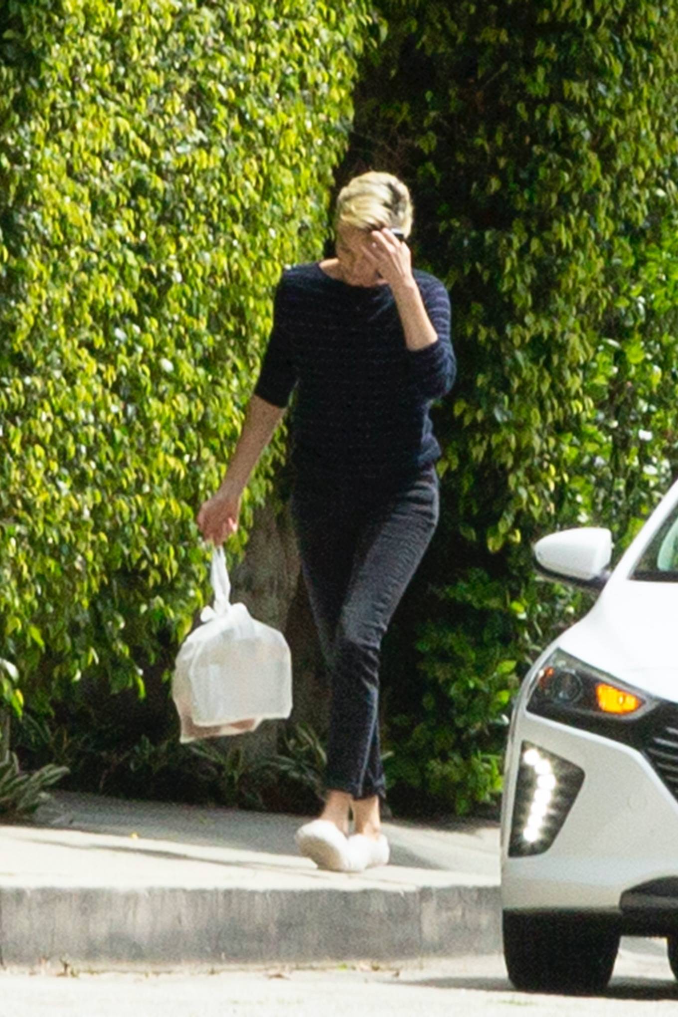 Charlize Theron â€“ Take her delivery outside her home in Los Angeles