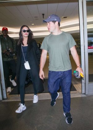 Chloe Bridges and Adam DeVine at Los Angeles International Airport in LA