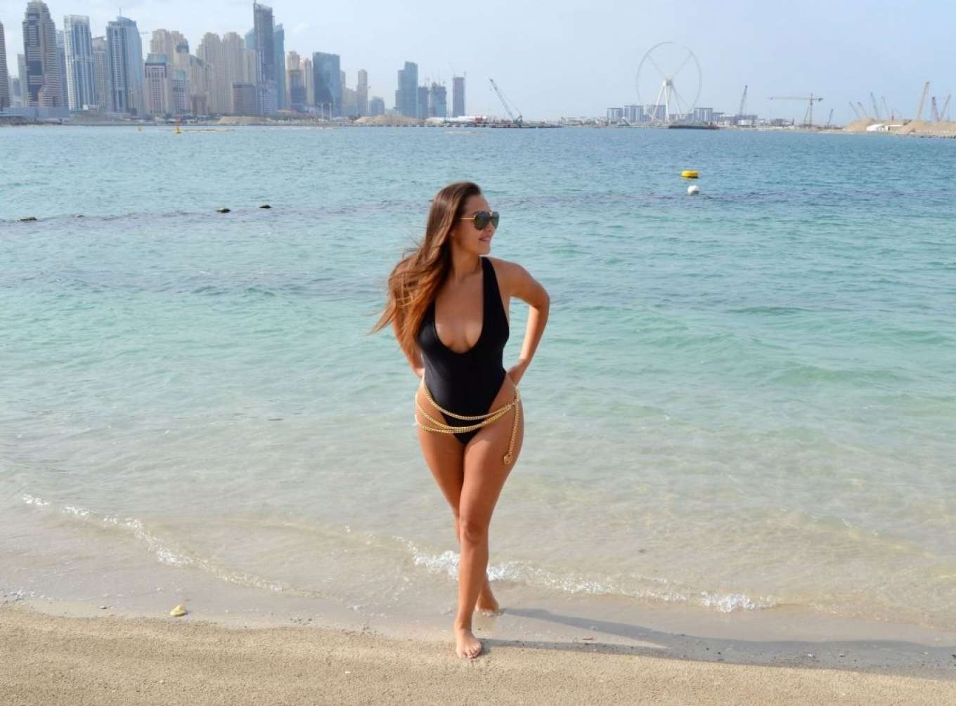 Chloe Goodman in Black Swimsuit on the beach in Dubai