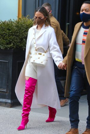 Chrissy Teigen - In thigh-high pink boots and a white dress out in New York