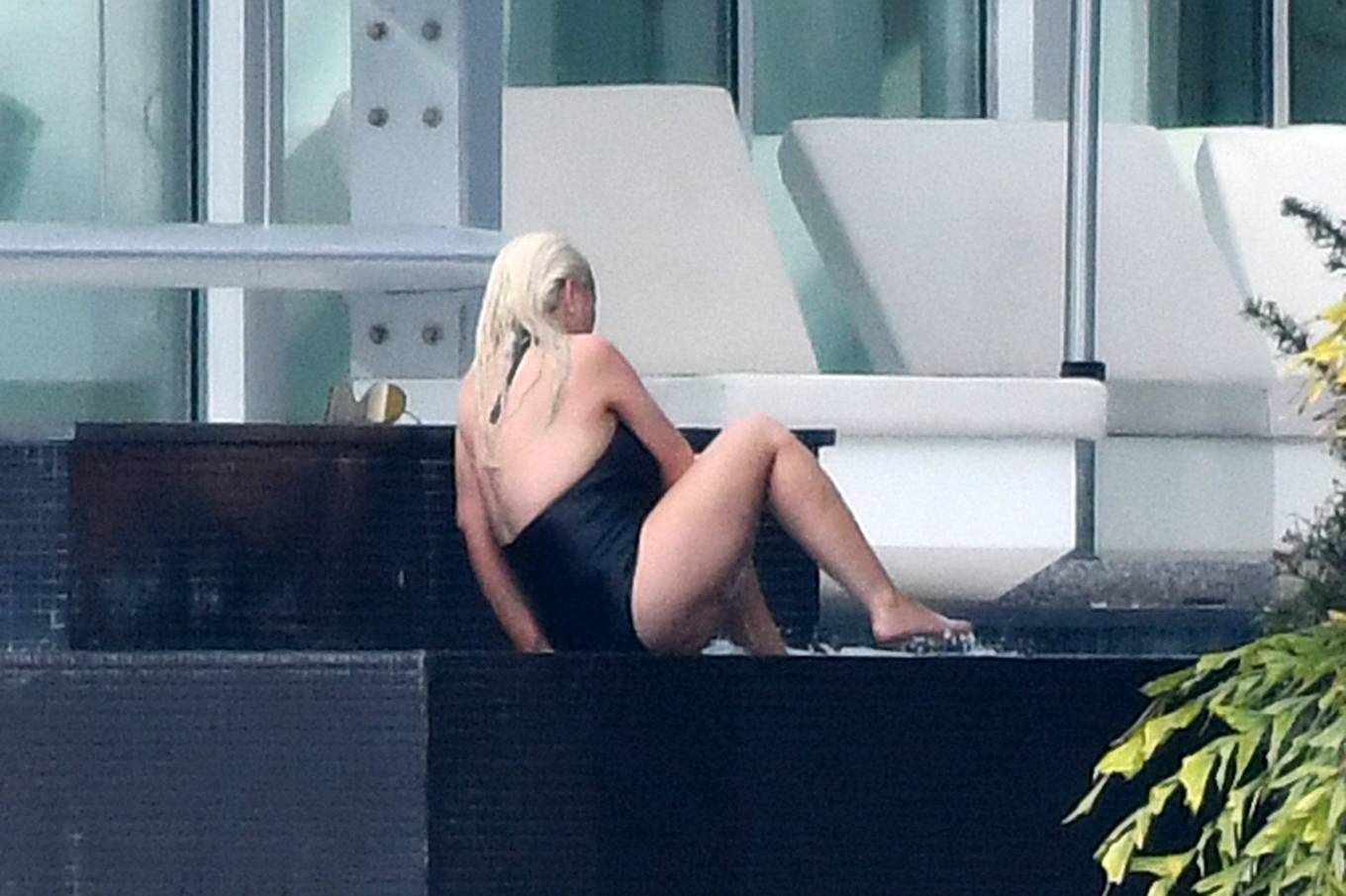 Christina Aguilera - Wears a black swimsuit in Miami.
