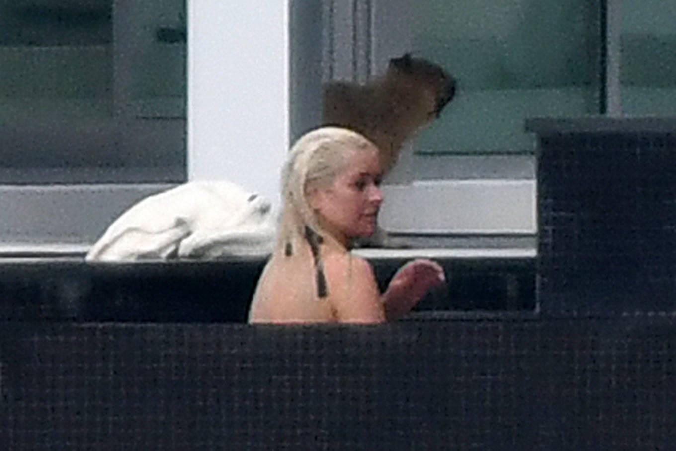 Christina Aguilera - Wears a black swimsuit in Miami.