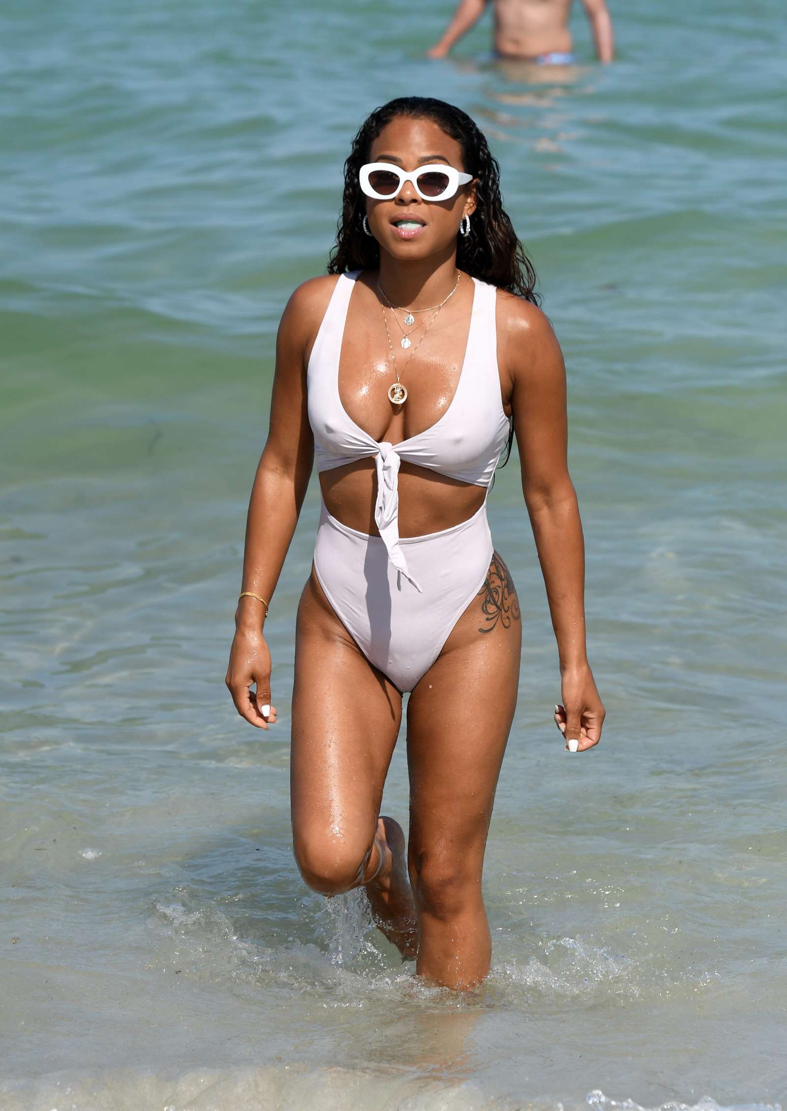 Christina Milian in White Swimsuit on the beach in Miami. 