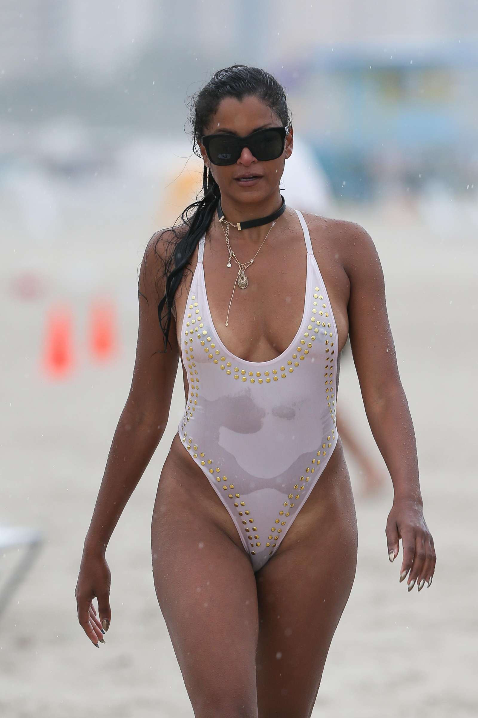 Claudia Jordan in White Swimsuit on the beach in Miami. 