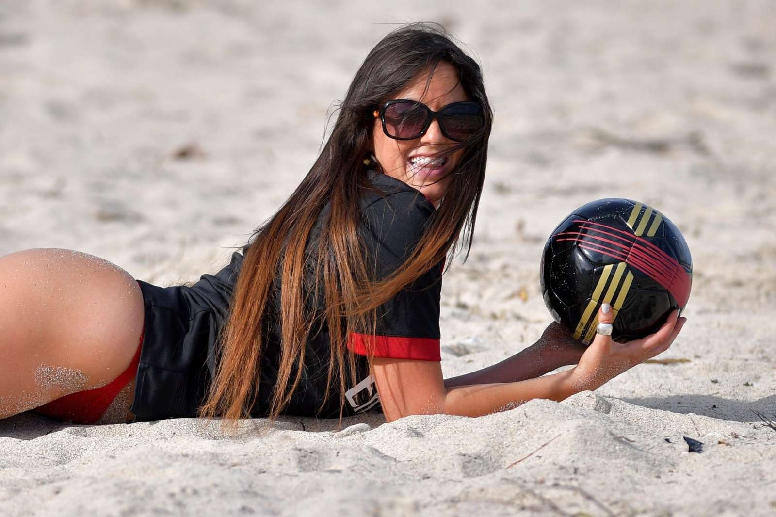 Claudia Romani in Red Bikini Bottoms on the beach in Miami. 