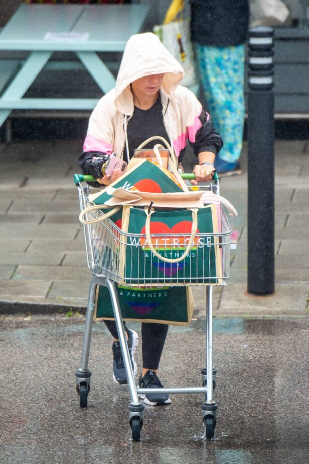 Coleen Rooney - Braves the rain to do grocery shopping in Alderley Edge