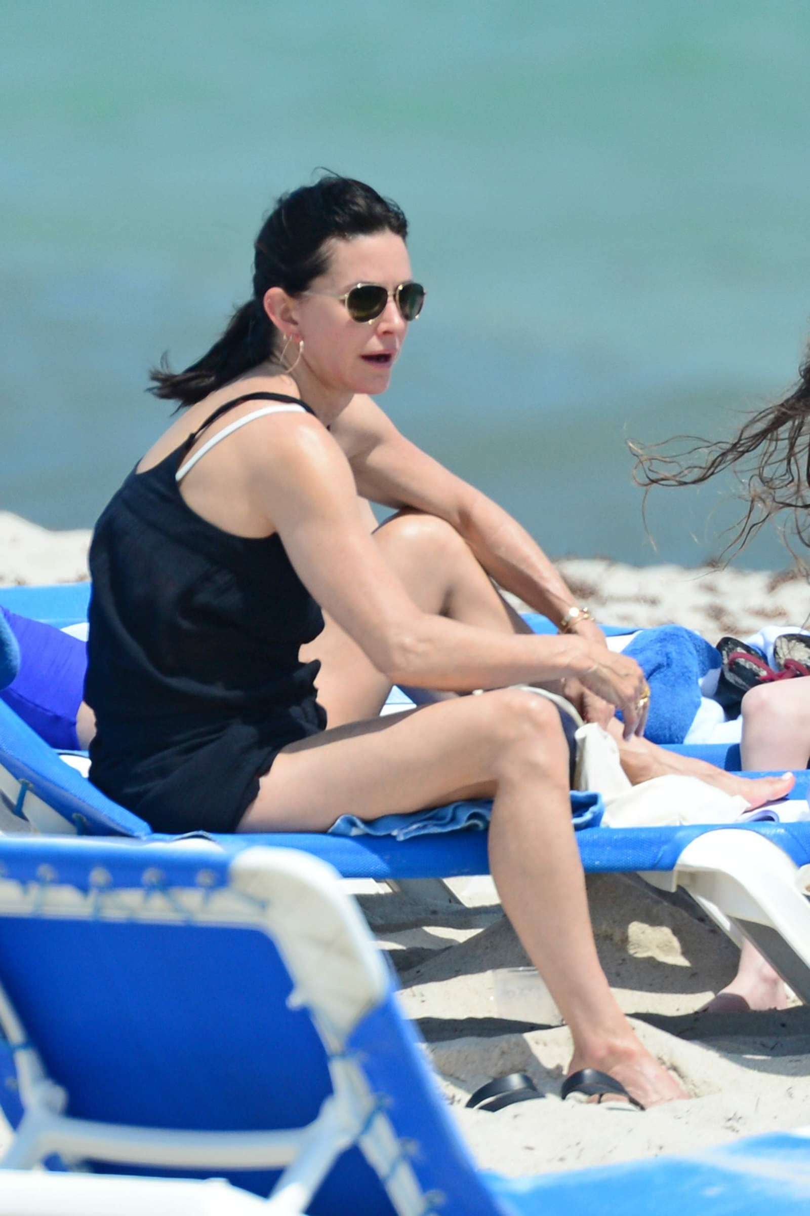 Courteney Cox in Black Bikini on the beach in Miami. 